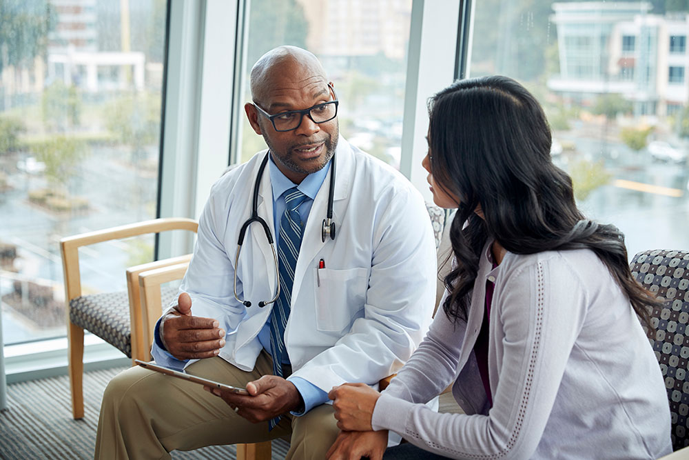Doctor talking to woman in medical office